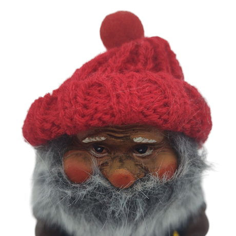 A close-up of the Nisse Man figurine, featuring a red knit hat, grey beard, and rosy cheeks with a hammer on a plain white background, capturing the charm of this Scandinavian piece.