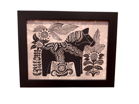 This black-framed artwork features a stylized Dala Horse adorned with decorative patterns, elegantly surrounded by large flowers and leaves; titled Dala Horse with Flowers Framed Batik Artwork, it measures 11x14.