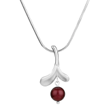 Inspired by Finnish jewelry, the Lingonberry Silver Necklace showcases a smooth curved pendant with a bold red bead set against a white backdrop.