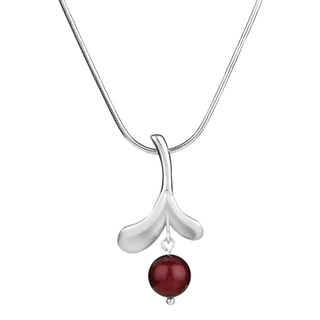 Inspired by Finnish jewelry, the Lingonberry Silver Necklace showcases a smooth curved pendant with a bold red bead set against a white backdrop.