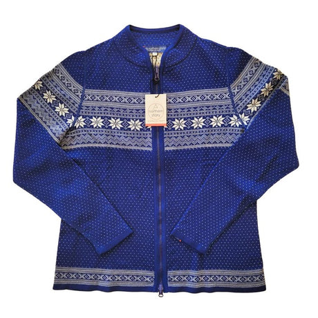 The Northern Story Setesdal Royal Blue Norwegian Design Wool Cardigan features white Nordic patterns on blue wool, zip-up front, and comes displayed flat with a tag attached to the collar.