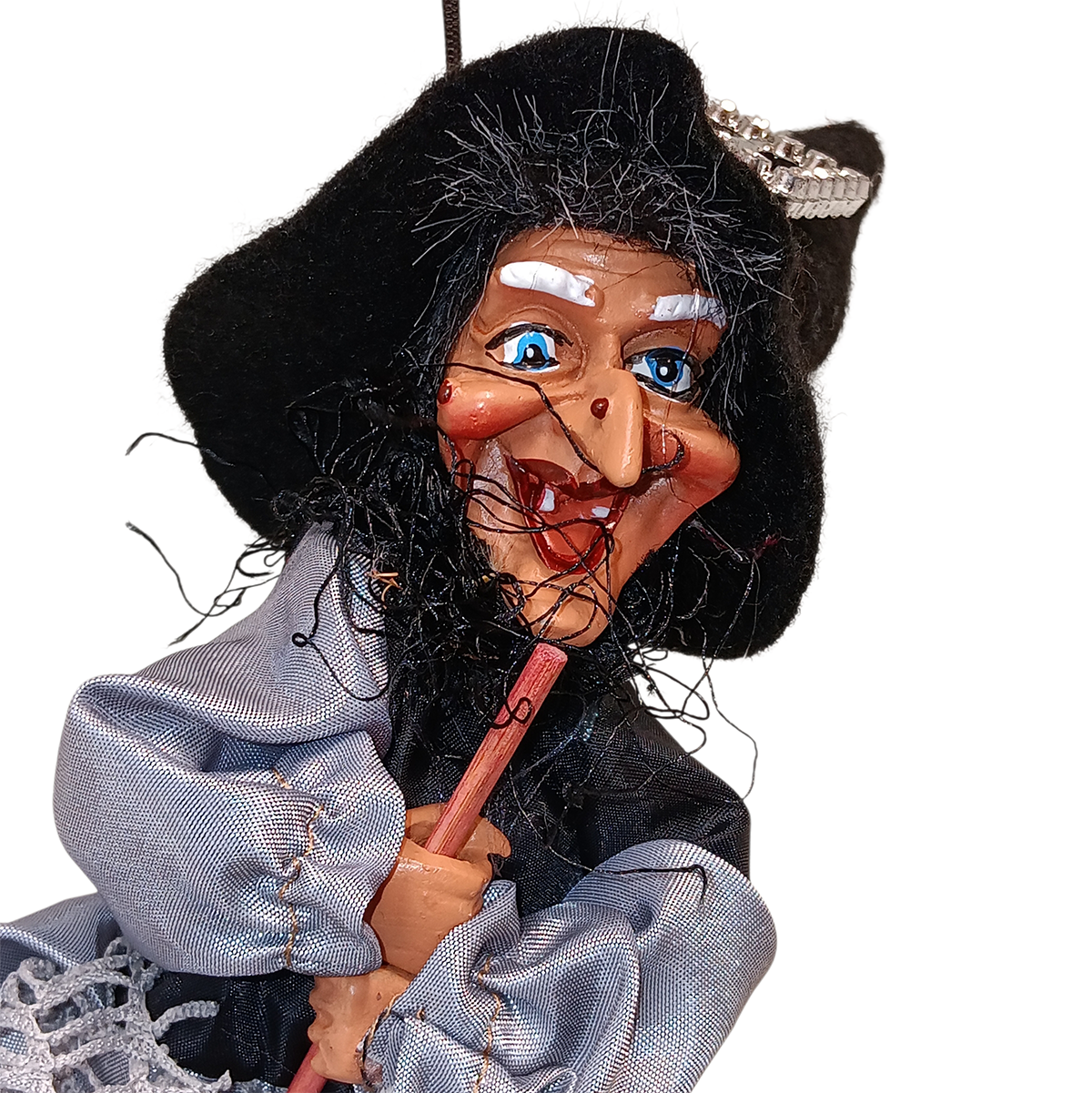 A close-up of the Figurine: Kitchen Witch Doll – Sirene Silver (10.2" Tall) with a large nose, blue eyes, black hat, and gray clothing, holding a broomstick for good luck as inspired by Northern European folklore.