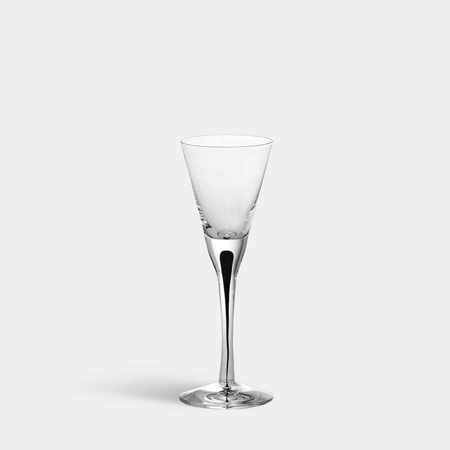 A slender-stemmed, clear champagne flute crafted by Orrefors and designed by Erika Lagerbielke is set against a white background.