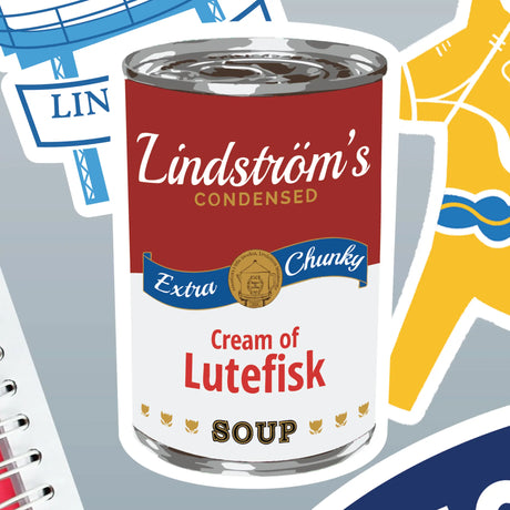 Soup can labeled “Extra Chunky Cream of Lutefisk Soup” surrounded by colorful Nordic-themed stickers and a sticker with an illustrated lutefisk.