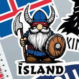 Cartoon Viking with helmet, axe, and shield stands in front of the Iceland flag; “Island” appears in bold letters below. Sticker design.