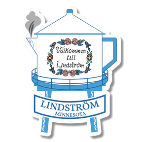 Blue and white sticker showing a water tower with floral accents, a ribbon reading Lindström Minnesota, and a steaming Swedish coffee pot spout on the left side.