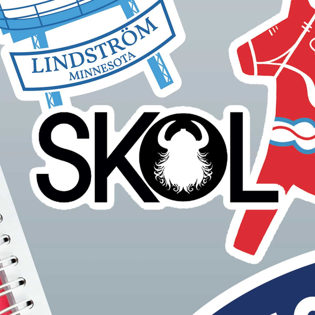 Sticker with a Viking helmet and “SKOL” lettering, surrounded by Nordic designs and Minnesota icons on a gray background.