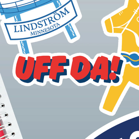 Sheet of Nordic stickers on gray surface, including a bold red and blue UFF DA sticker, a partial yellow Dala horse, and a LINDSTRÖM MINNESOTA sign.
