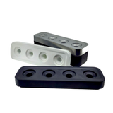 The Stumpastaken Swedish Candle Holder, shown in black, white, and gray with four circular holes each, is stacked at angles against a white background—an eco-friendly way to hold 4 candles.