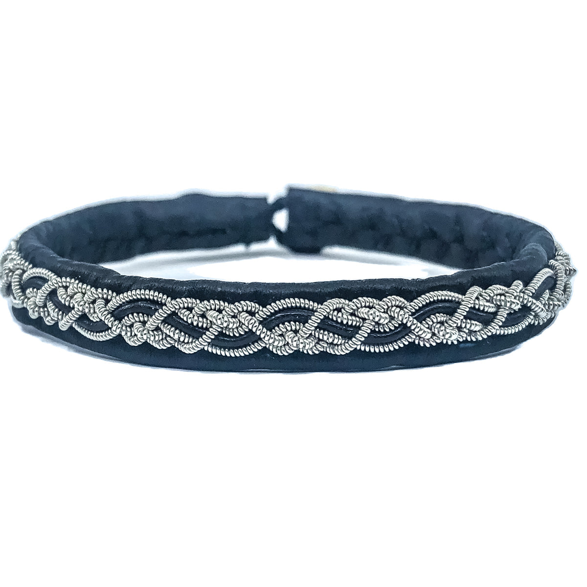 The Sami Svea Black 16.5cm bracelet features a silver braided design on a naturally tanned reindeer skin strap with an intricate knot pattern and a unique reindeer antler button.