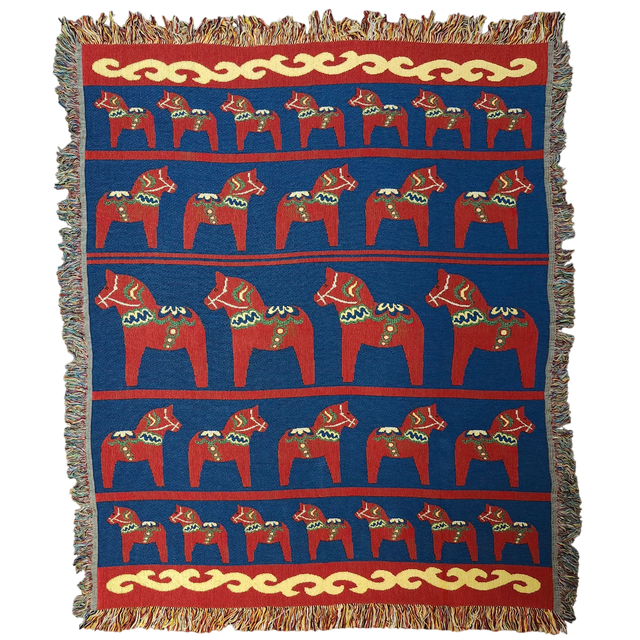 The Swedish Passport Co Blanket: Swedish Dala Horse 100% Cotton Woven Blanket (50"x60") features rows of red Dala horses and yellow fringe on a blue background—an ideal Nordic decor accent.