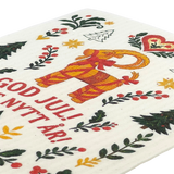 Card featuring a red and yellow Yule Goat, Christmas trees, hearts, stars, and the text “God Jul! Gott Nytt År!” on a light background.