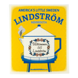 Eco-friendly kitchen cloth featuring a yellow sign with the Lindström teapot-shaped water tower and the Swedish phrase “Välkommen till Lindström.”.