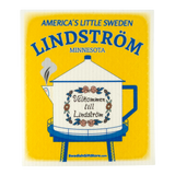 Eco-friendly kitchen cloth featuring a yellow sign with the Lindström teapot-shaped water tower and the Swedish phrase “Välkommen till Lindström.”.