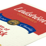 Close-up of a lutefisk soup can label with “Lindströms Condensed” in white and yellow text on red and white background, featuring a gold and blue emblem.