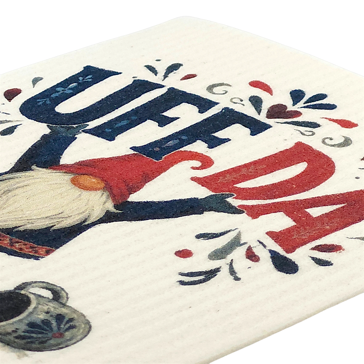 Swedish dishcloth with a gnome holding up “UFF DA” in bold blue and red letters, surrounded by decorative hearts and a coffee pot.