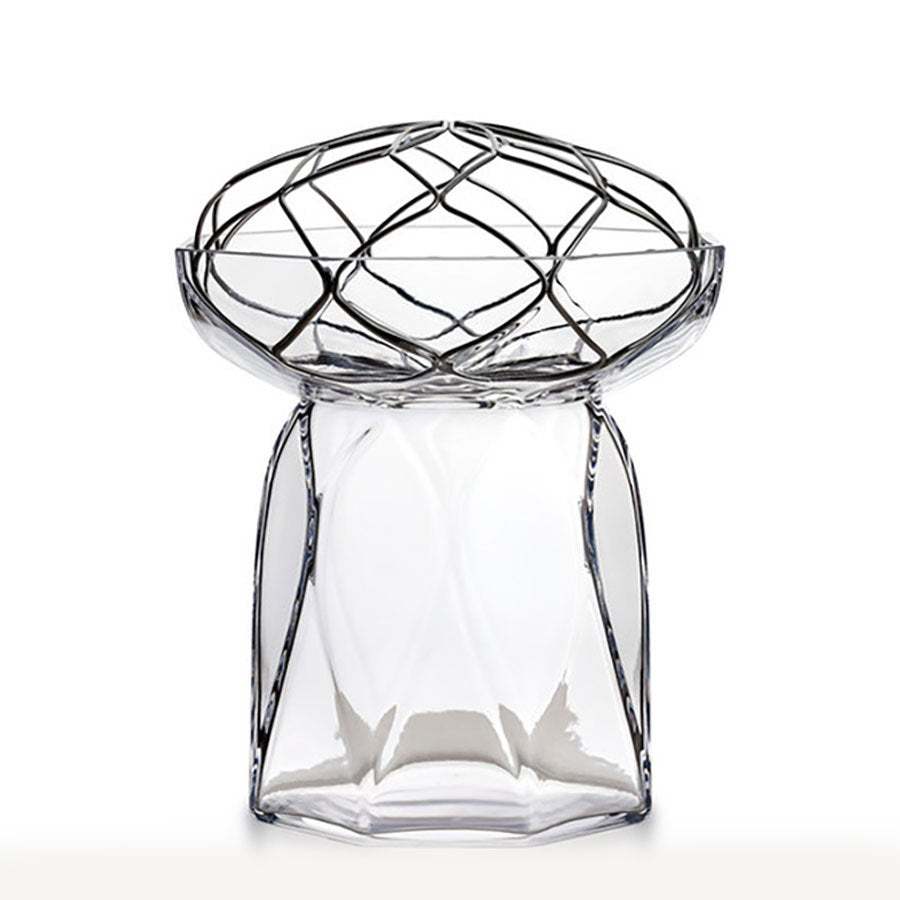 The Orrefors: Bloom Vase Tall, designed by Lisa Hilland, showcases a transparent glass body with an intricate geometric web-like pattern on top, set against a plain white background.