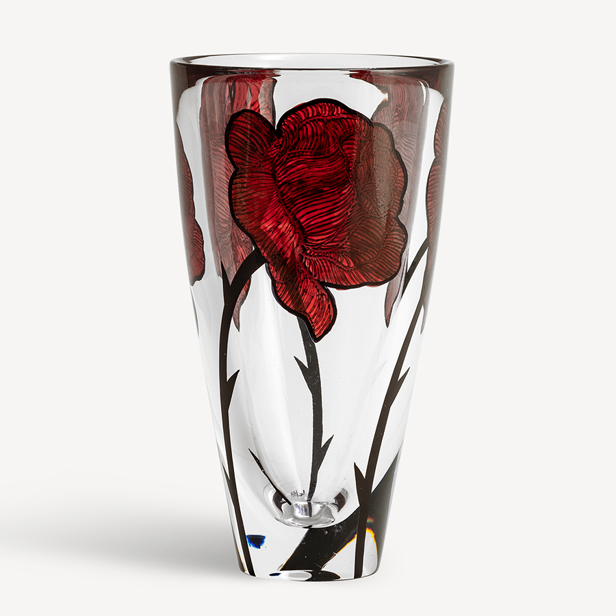 Introducing the KostaBoda: Tattoo Vase, a clear glass masterpiece with hand-painted red rose designs and black stems on a crisp white background. This elegant piece showcases Kosta Bodas artistry, adding sophistication to any space.