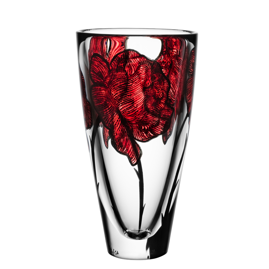 The KostaBoda: Tattoo Vase is an exquisite clear glass piece with hand-painted red floral patterns etched into its surface, offering an elegant and timeless design.