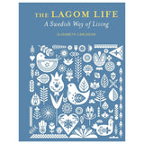 Book: The Lagom Life: A Swedish Way of Living by Elisabeth Carlsson features white folk art birds, flowers, and leaves on a blue cover, capturing the spirit of lagom and Swedish living.