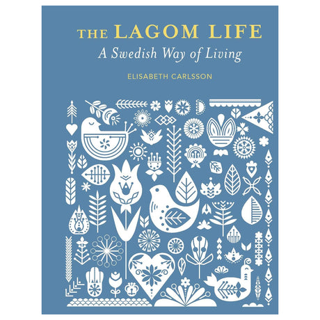 Book: The Lagom Life: A Swedish Way of Living by Elisabeth Carlsson features white folk art birds, flowers, and leaves on a blue cover, capturing the spirit of lagom and Swedish living.