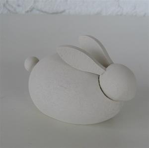 A smooth, oval-shaped rabbit sculpture with prominent ears and a round tail, like the Swedish Handcrafted Wooden Rabbit Figurine, set against a plain background.