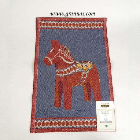 A vibrant tea towel named Dala Horse by Eckeland Master Weavers features a traditional Dala horse design in red and blue with kurbitsblom elements, crafted from organic cotton. The website www.grannas.com is displayed at the top. Dimensions: 14x20.