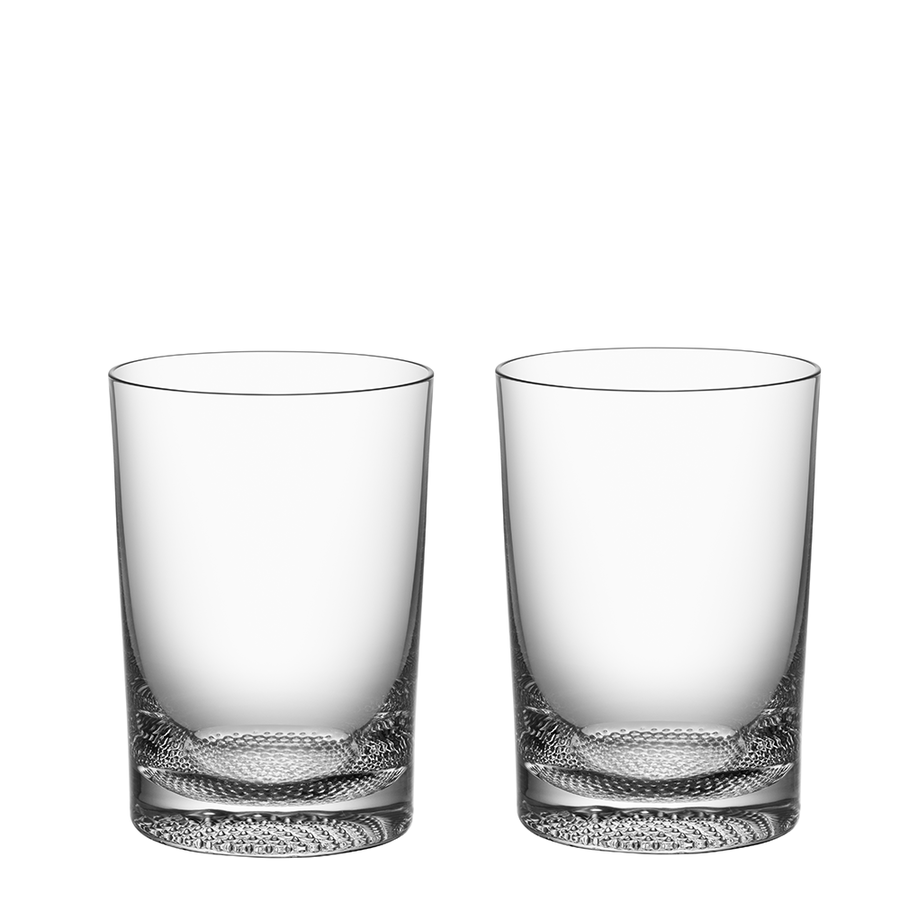 The KostaBoda Limelight Tumbler 7.5oz (2-Pack) features two handmade clear glasses with a textured base, elegantly set against a white background.