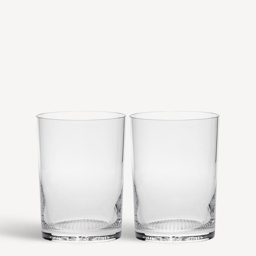 Two handmade KostaBoda Limelight Tumblers, each with a textured base and clear cylindrical design, are elegantly displayed against a white background.