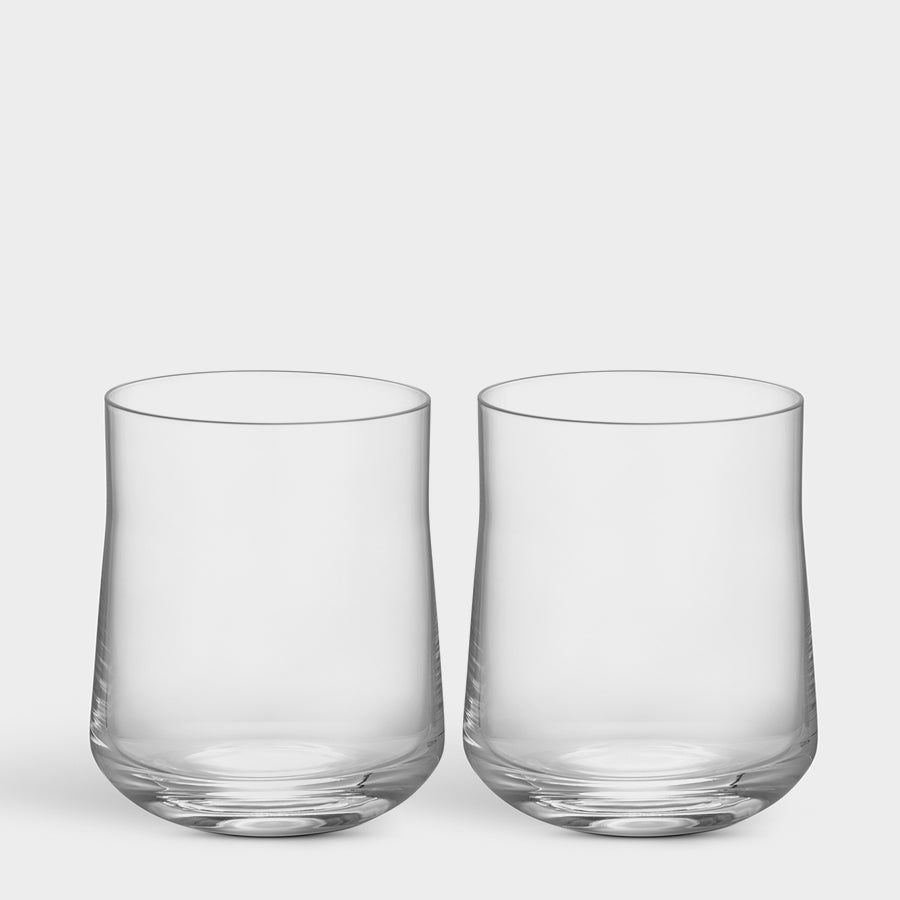 The Orrefors Informal Tumbler Large Glass (2-Pack) embodies Scandinavian design with two clear, stemless tumblers set against a plain background.