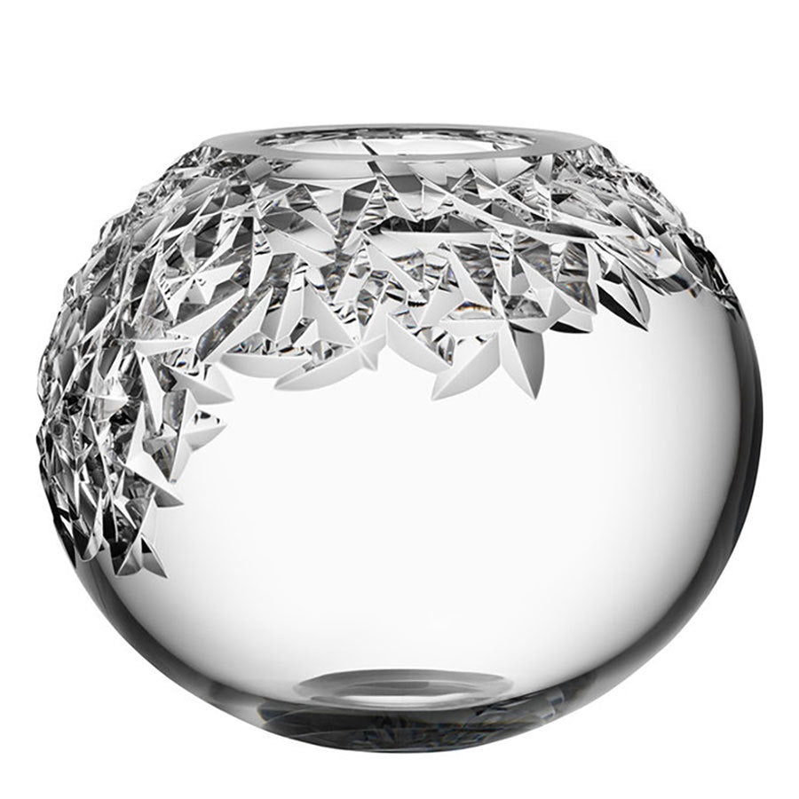 The Orrefors Carat Globe Vase XL is a stunning round crystal piece with intricate angular geometric patterns on the top half, set against a white background, showcasing Orrefors craftsmanship.