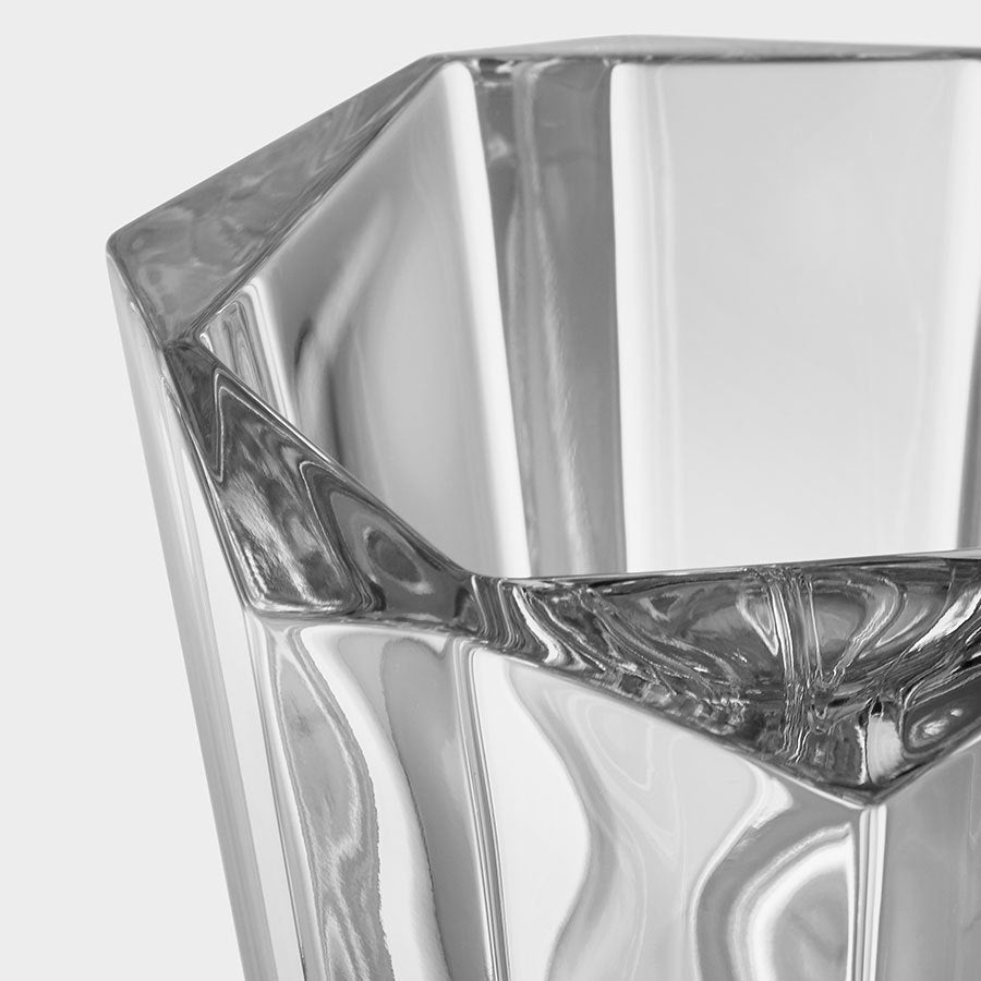 Close-up of an Orrefors: Precious Vase Large, designed by Malin Lindahl, showcasing its faceted geometric surfaces with reflections and light refractions.