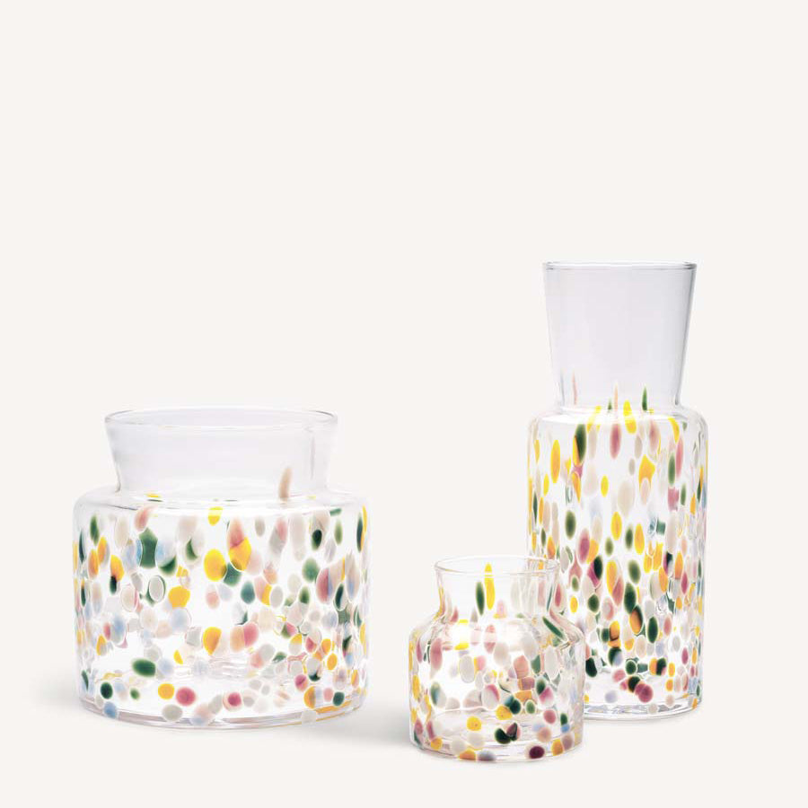 The KostaBoda: Meadow Vase Spring Tall, along with two other glass vases featuring colorful speckled patterns, in various heights and shapes, are showcased against a light background.