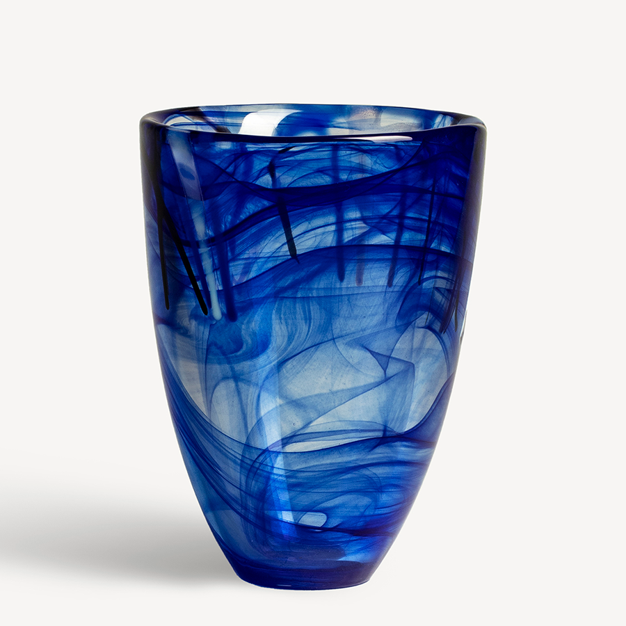 The KostaBoda: Contrast Vase Blue, featuring swirling patterns in various shades, captures Anna Ehrners signature style and stands elegantly against a white background.