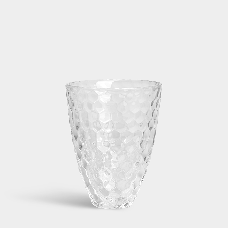The Orrefors: Raspberry Vase Small, with its honeycomb texture, captures timeless elegance as it stands gracefully on a plain gray background.