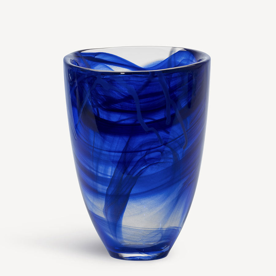 The KostaBoda: Contrast Vase Blue, featuring swirling patterns on glass, beautifully embodies the brands essence against a plain background.