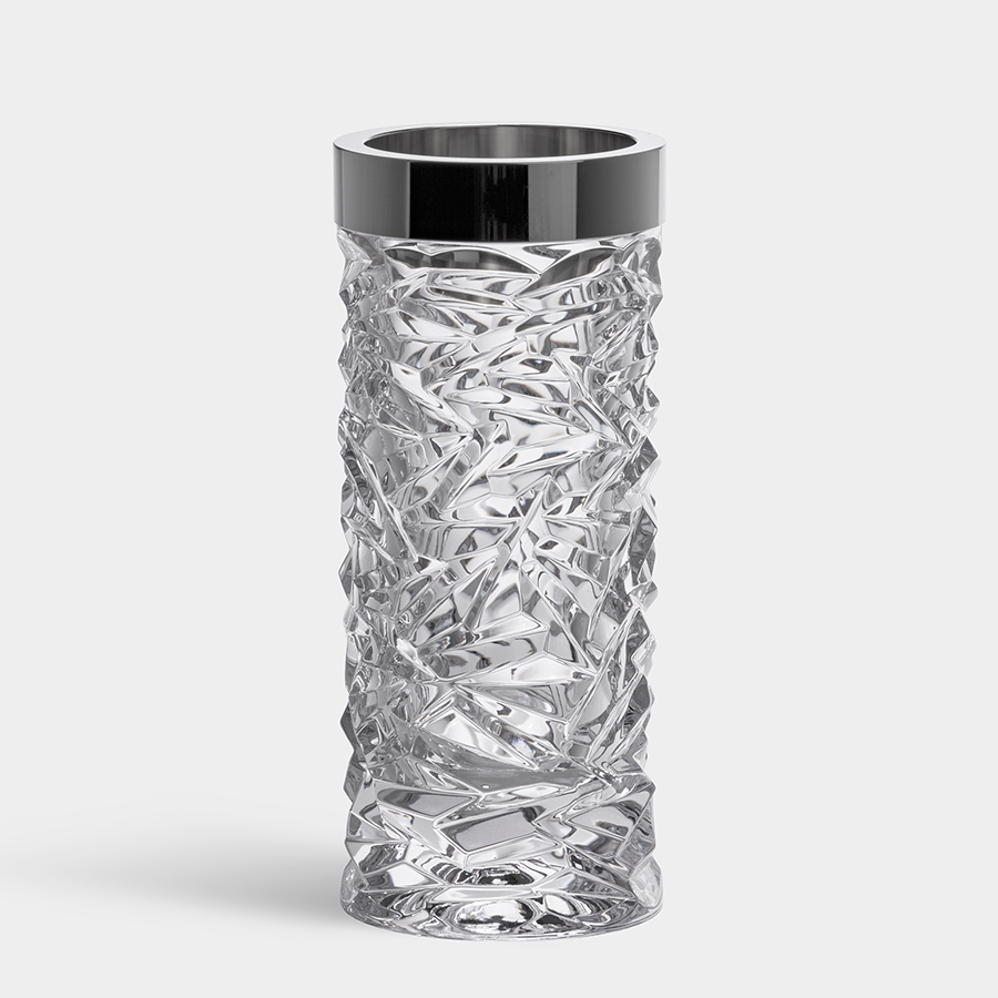 The Orrefors Carat Vase is a tall, clear crystal vase featuring a textured, intricate design with a shiny silver rim, set against a plain white background.