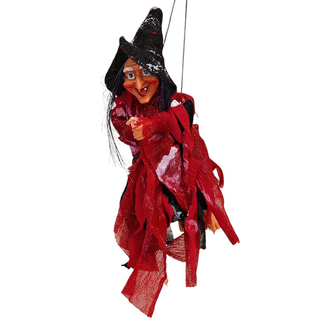 The Walburga Red Kitchen Witch Doll, handmade in Germany, features a pointed hat, red and black outfit, and exaggerated facial features. This hanging doll is believed to bring good luck and is shown isolated on a white background.