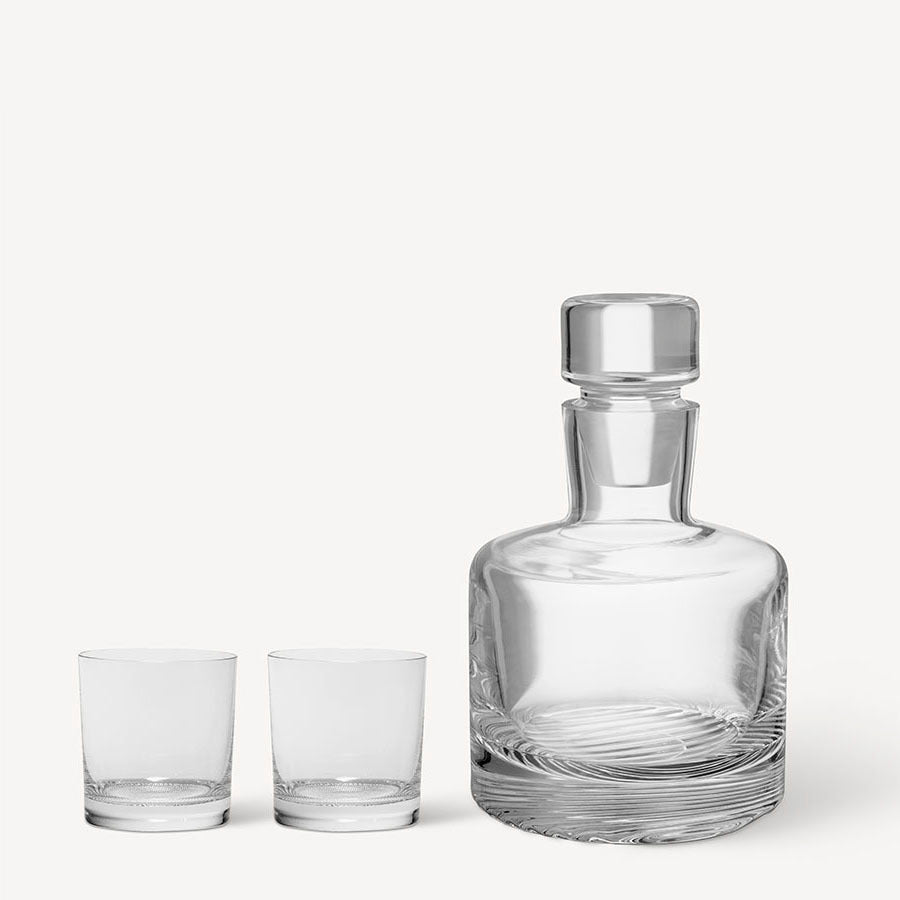 Against a plain background is the KostaBoda Wave 3 Piece Gift Set, including one clear glass decanter with stopper and two matching double old fashioned glasses.