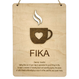Wooden wall plaque with a coffee cup and heart cutout, labeled FIKA in bold letters. Scandinavian design elements visible.