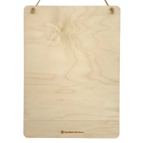 Rectangular wooden plaque with visible grain, hung by two strings. A small Swedish Gift Store logo appears at the bottom. Scandinavian design elements are present.