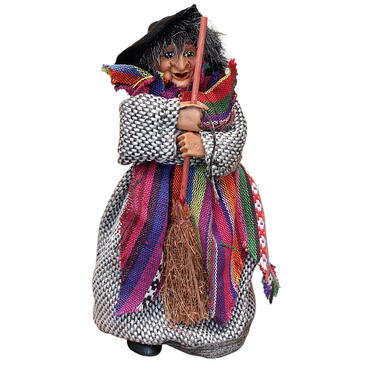 The Kitchen Witch: Yasmina Purple Standing Kitchen Witch Doll, inspired by Scandinavian folklore, wears a patterned dress, colorful scarf, and black hat while holding a twig broom—serving as a protective household talisman.