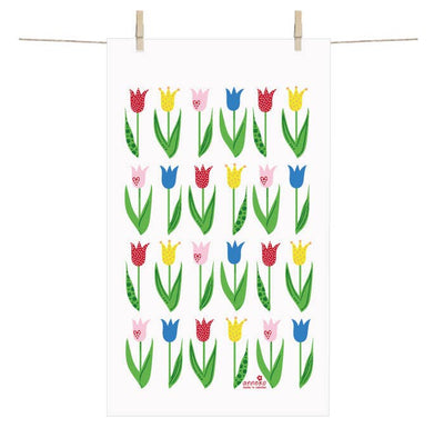 A Tulip Terry Cotton Hand Towel (12" x 20") with a grid of colorful stylized tulips, inspired by Anneko Design Sweden, is displayed hanging from two clothespins on a line.