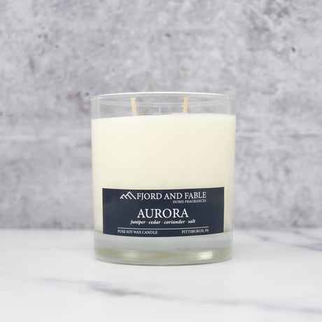 The Aurora Candle by Fjord & Fable is an 8oz Scandinavian-inspired soy wax candle in a glass jar with a 45+ hour burn time.