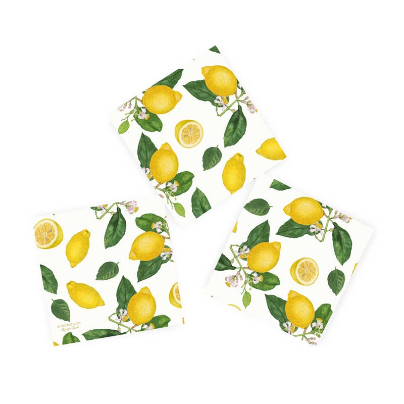 Three square Lemon Paper Napkins featuring a design of lemons and leaves on a white background, made from recycled FSC paper.