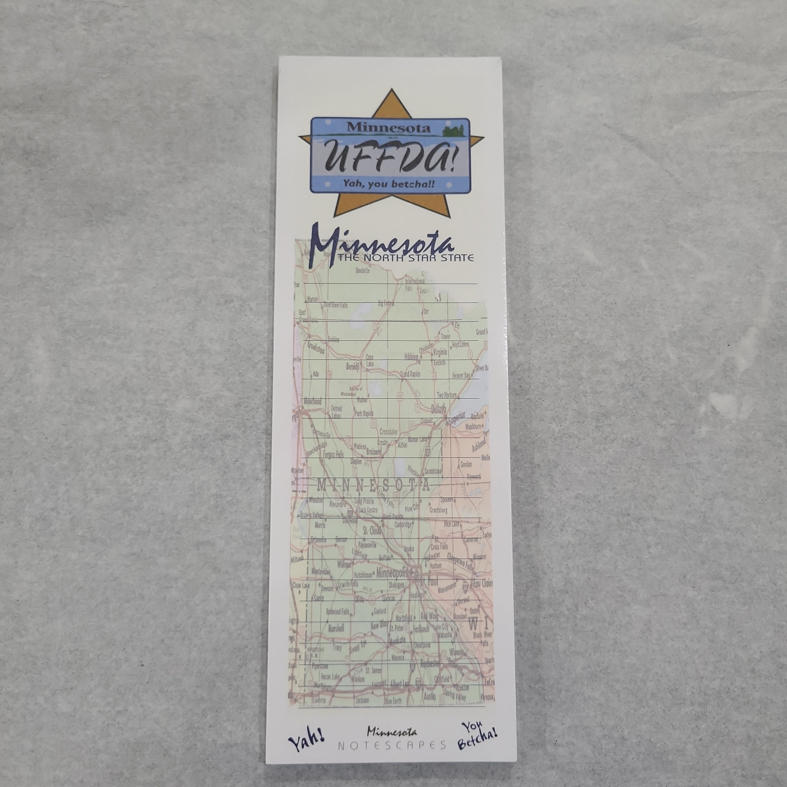 A Tablet: MN Uffda Writing Pad featuring a map of Minnesota with "Uffda! Yah, you betcha!" written at the top.