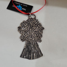 The Ornament: 2022 Pewter Tree Tinn Per is a silver-colored tree-shaped ornament with detailed leaves and trunk, featuring a red ribbon and black tag—ideal for holiday décor.
