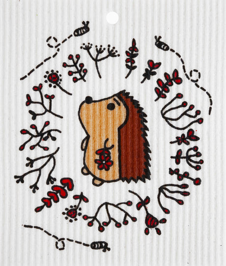 A cartoon hedgehog illustration with red berries and twigs on a textured, biodegradable background, similar to the Hedgehog Swedish Dish Cloth.
