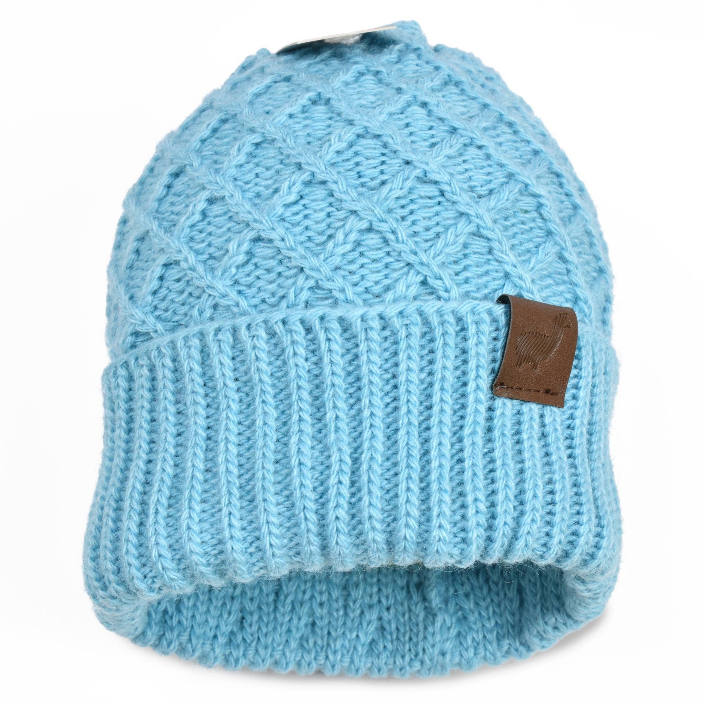 The Citi Fashion Genuine Baby Alpaca Double Knit Beanie features a light blue knit, ribbed fold-over brim, and brown leather patch, inspired by classic Peruvian alpaca hats.