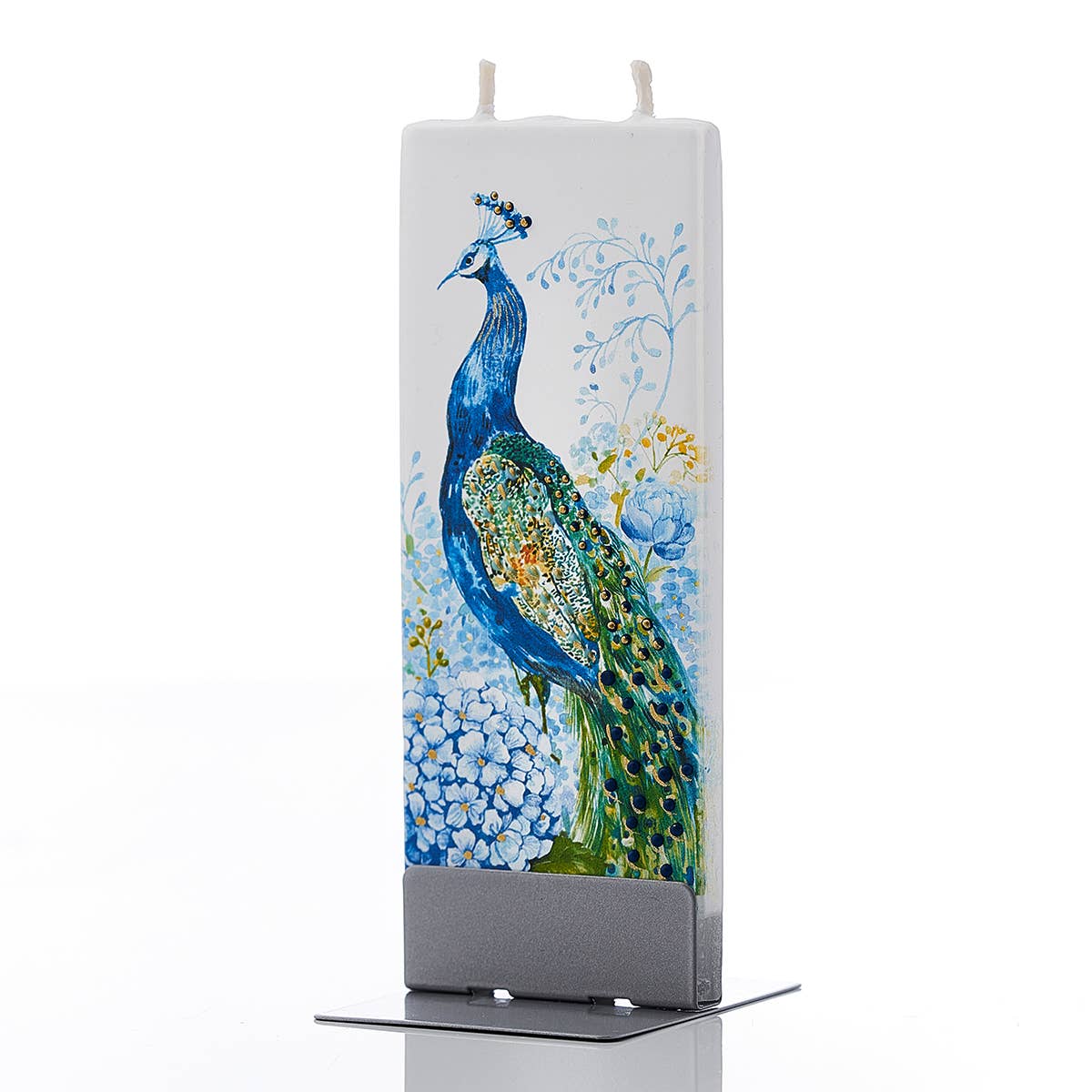 The "Candle: Peacock in Flowers - Flat Candle" is a rectangular white handmade candle with twin wicks, featuring a colorful hand-painted peacock and floral design, elegantly set on a square metallic base.